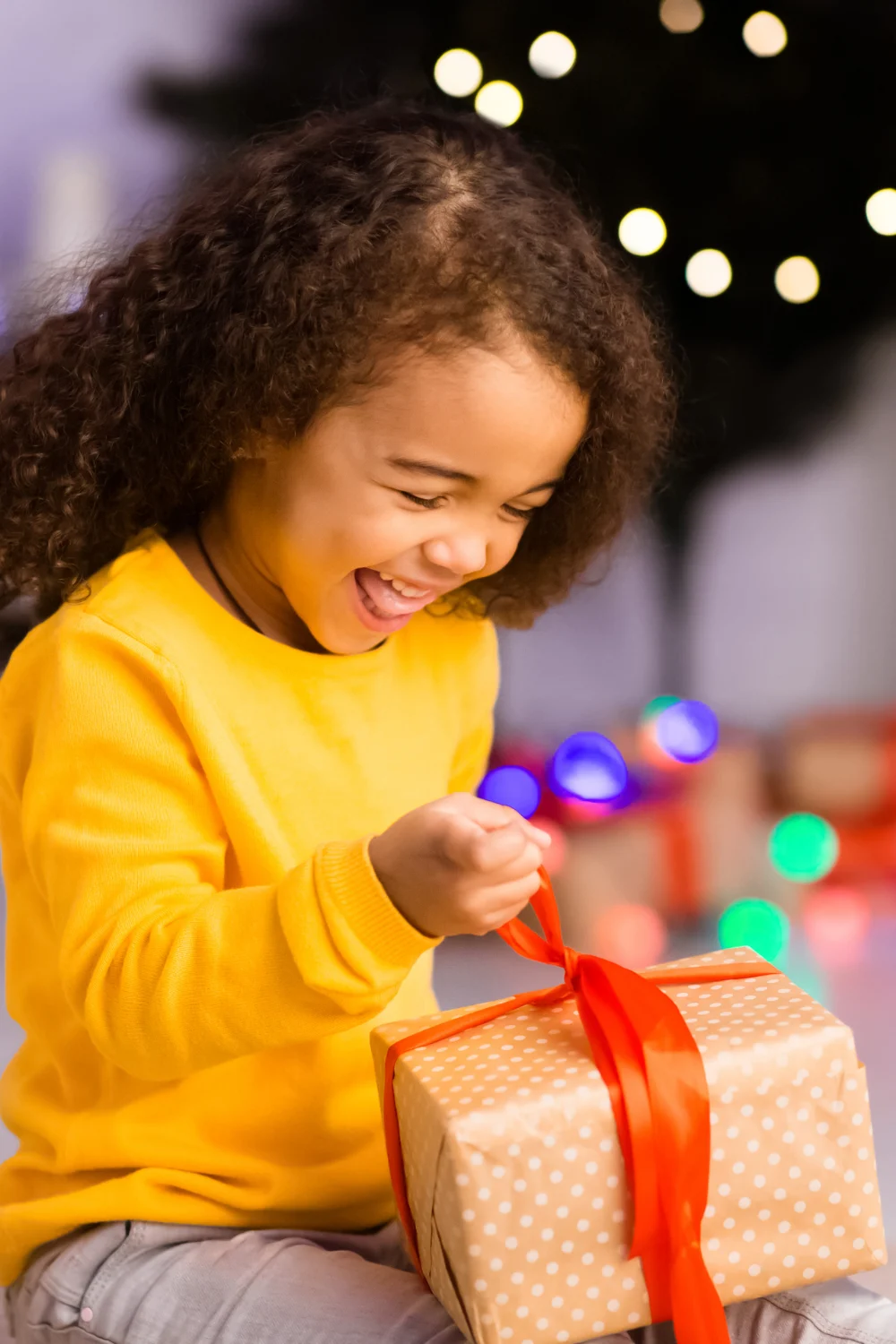 happy toddler opening gifts for Christmas