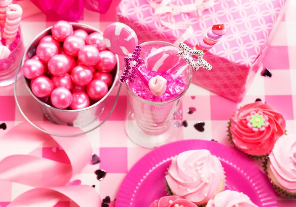 cupcakes, wands, candy balls and wrappers all in pink hue