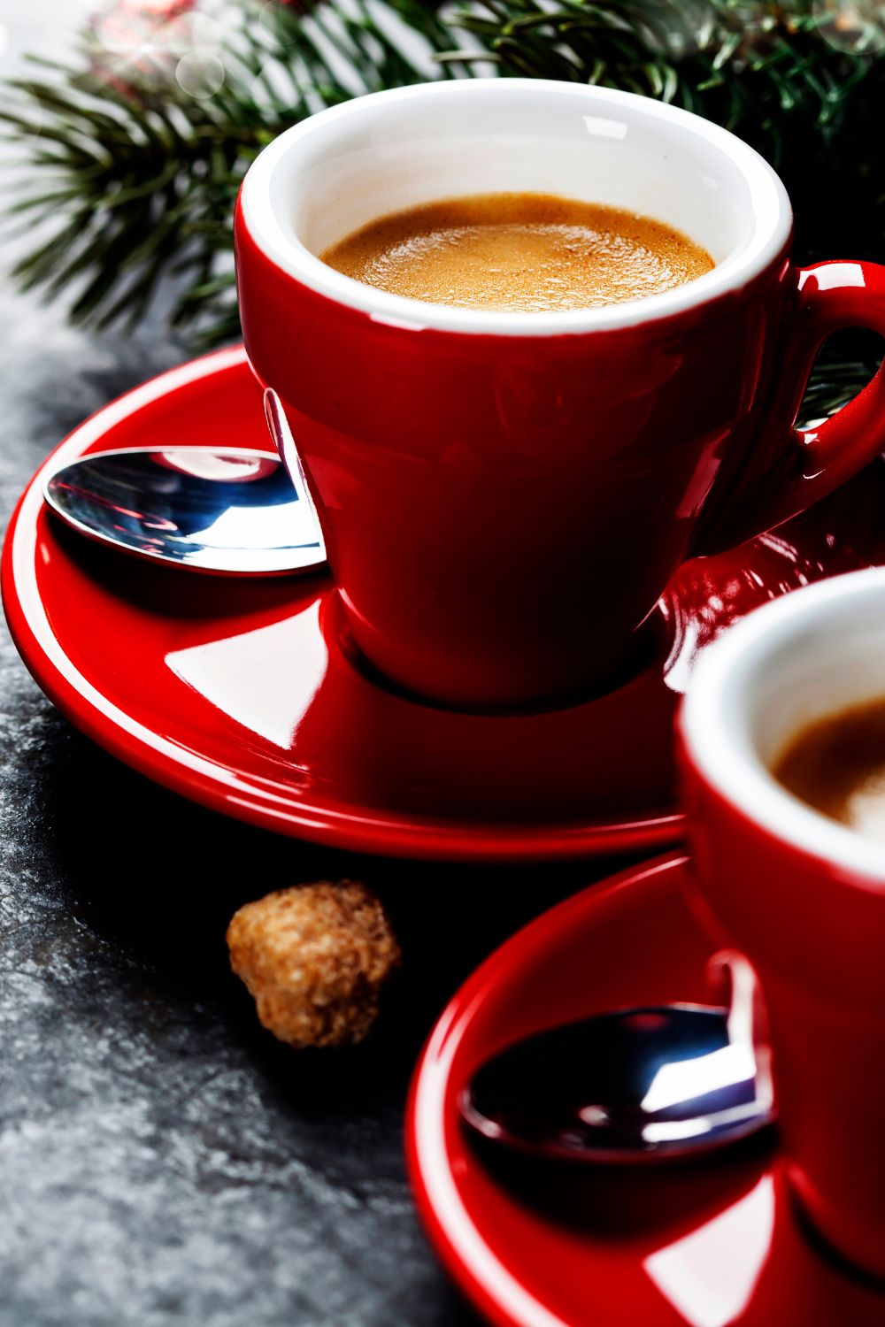 a cup of coffee in red mugs with Christmas wreath